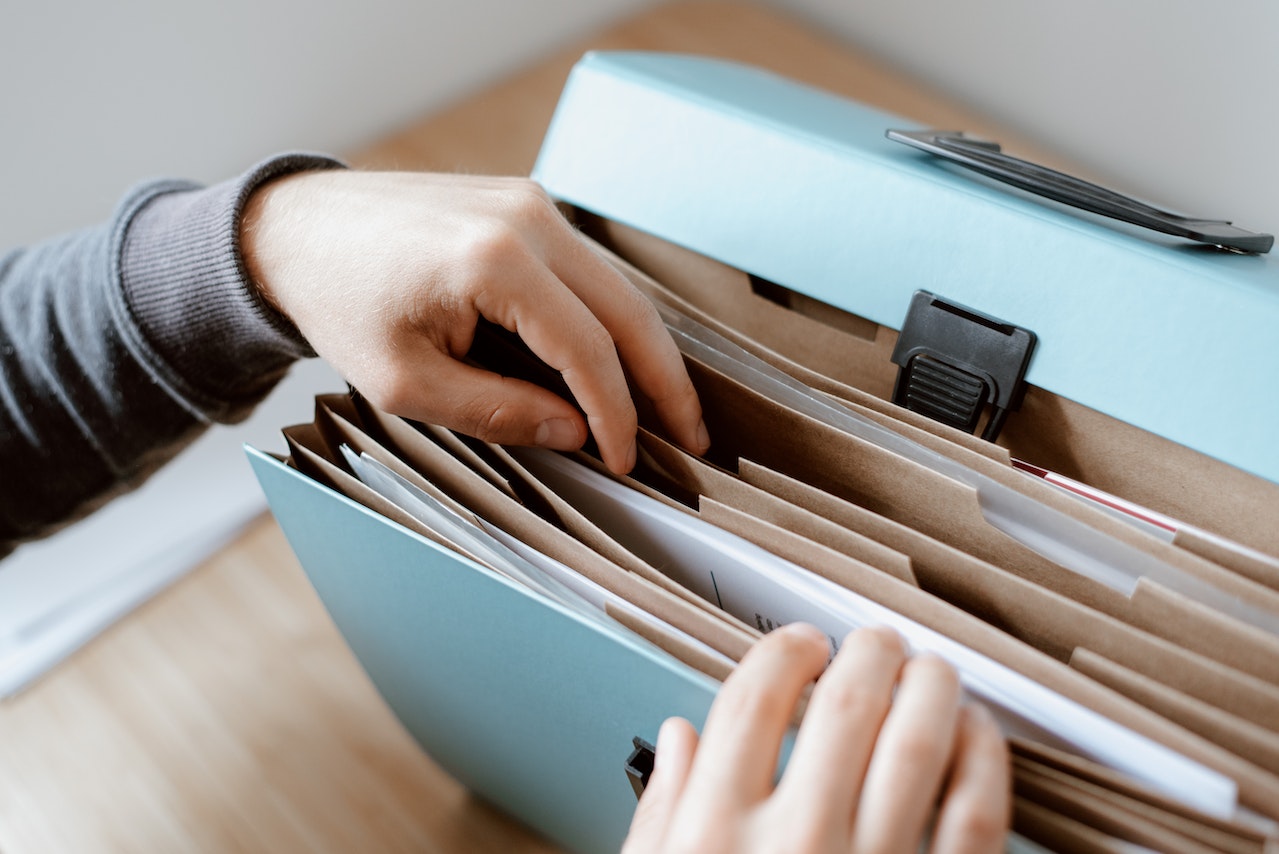 This picture shows a person sorting documents on a folder.