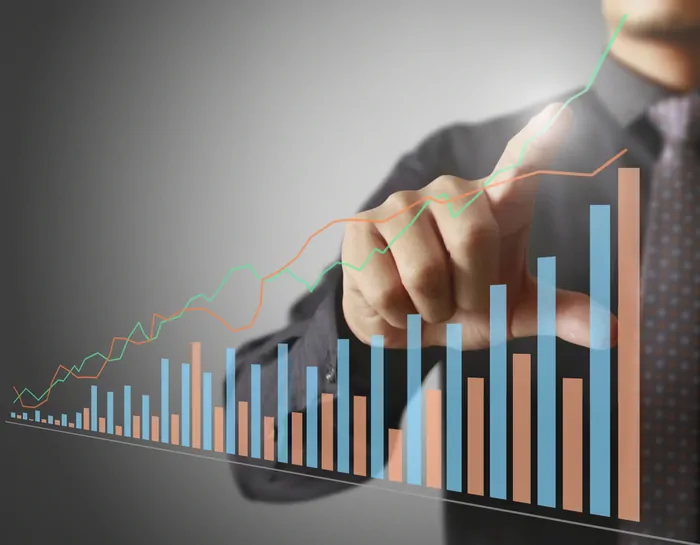 Businessman hand tracing increasing lines on a revenue graph