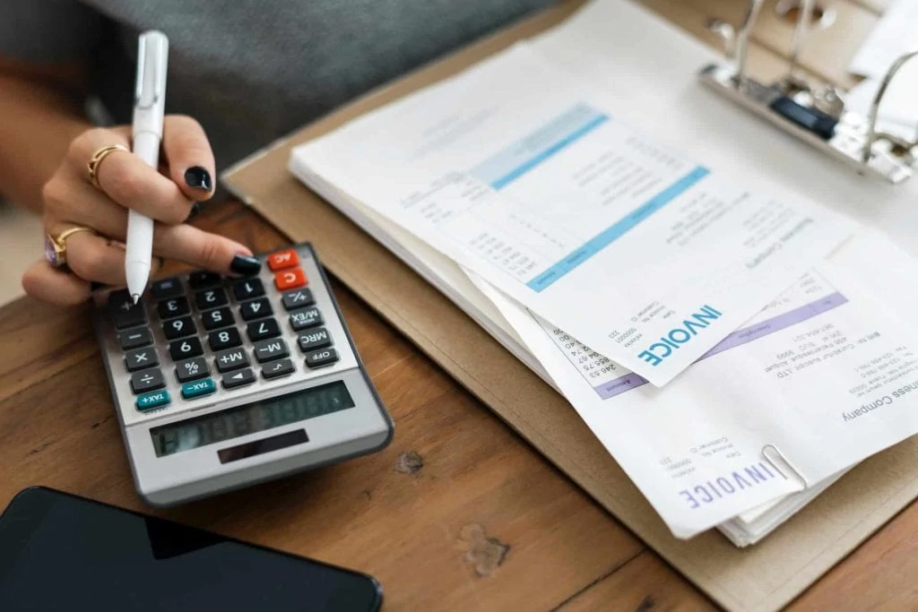 Image of a calculator and paper invoices.