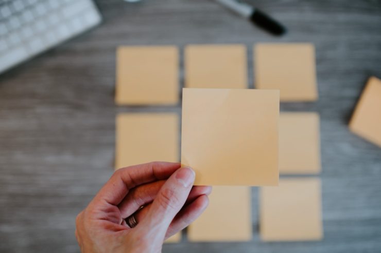 Hand holding a post-it note