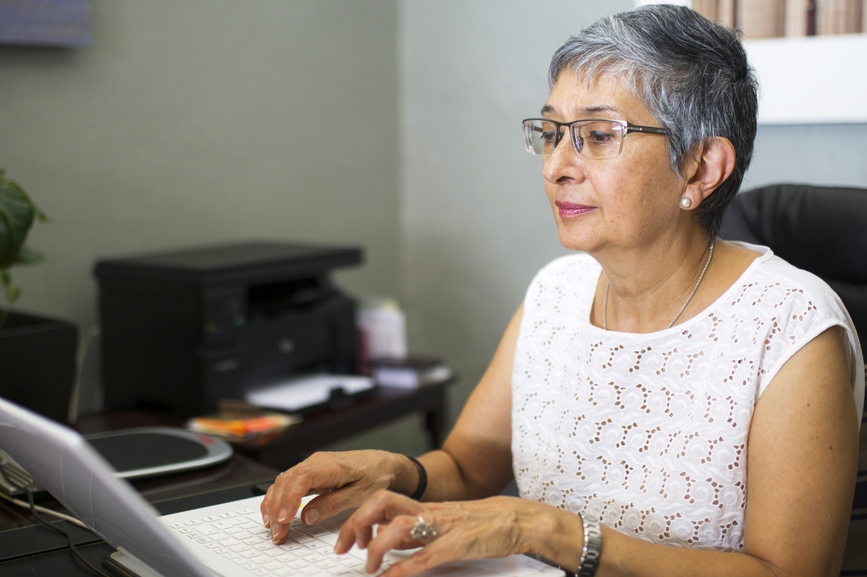 woman typing on laptop in office