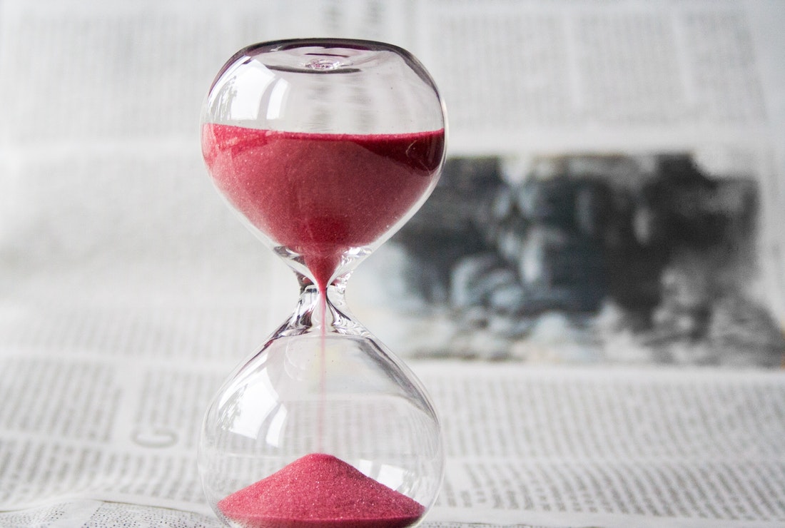 An hourglass represents the old ways that are being replaced by time tracking apps.