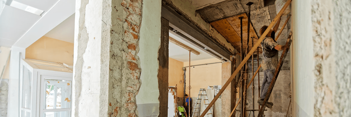 A worker in a house renovating it.