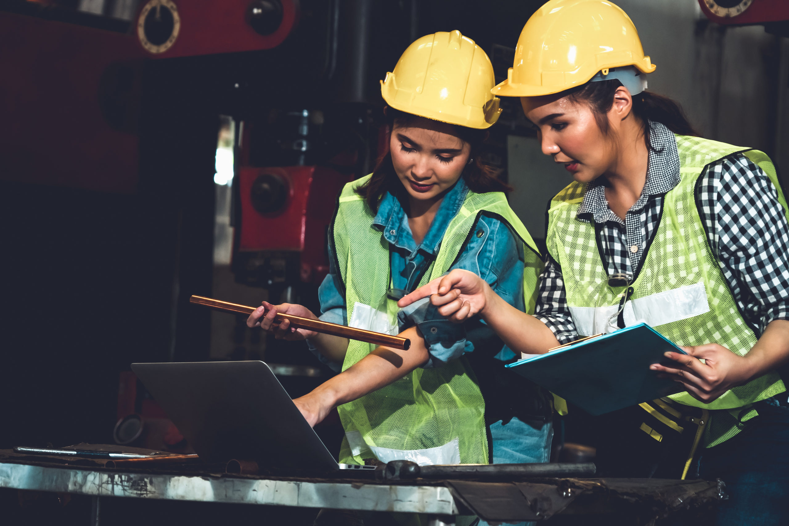 Factory job workers working and discussing manufacturing plan in the factory . Industry and engineering concept .