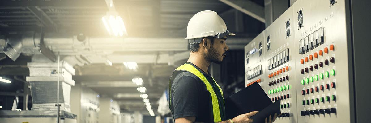 Electrical Engineer working front control panel