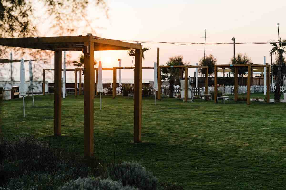 brown wooden post on green grass field during sunset