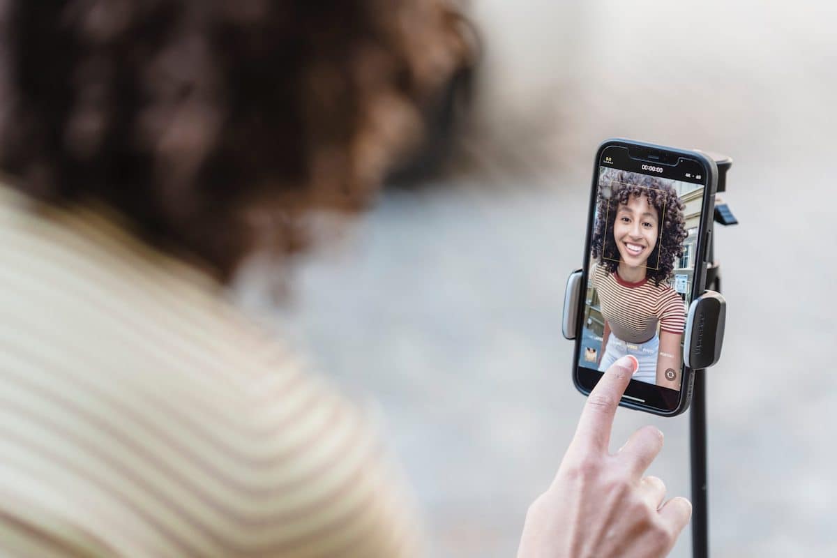 blogger recording video on smartphone on street