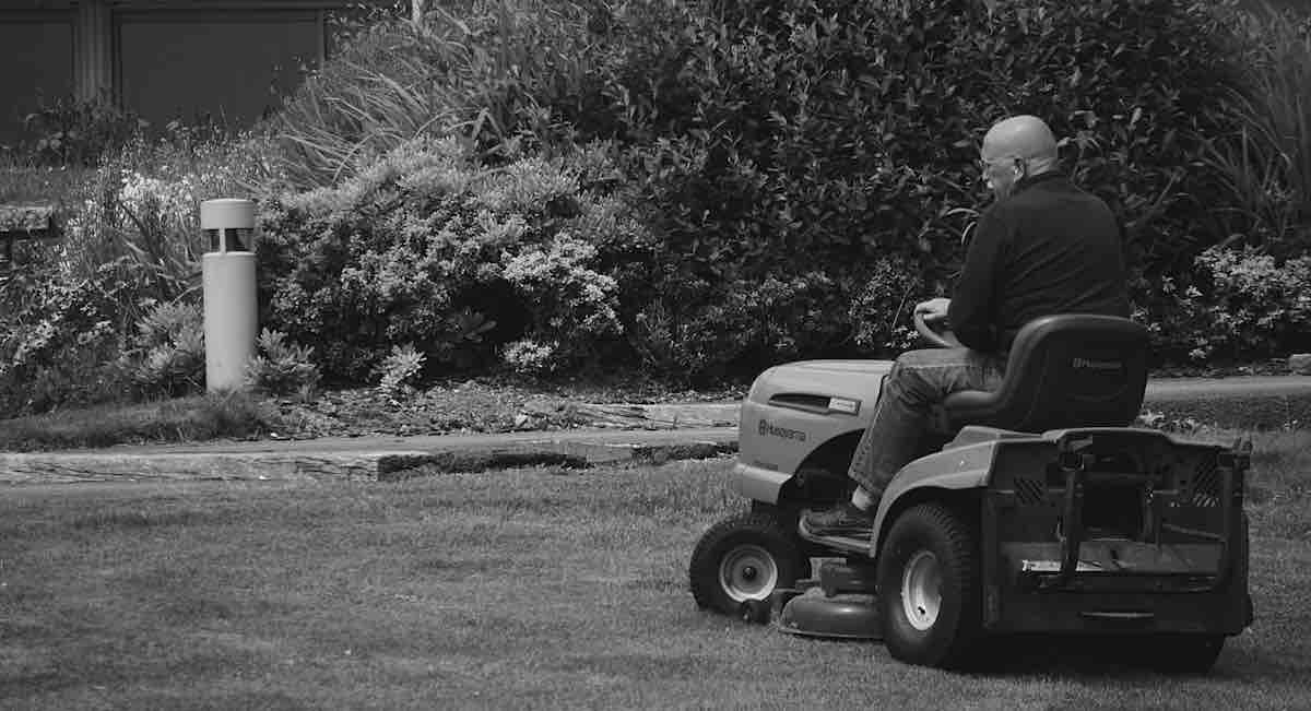 Man Riding a Lawn Mower Vehicle