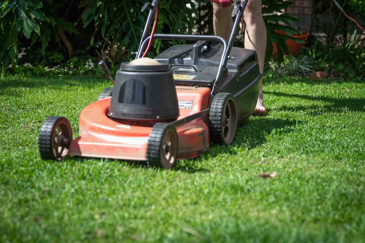 A lawnmower, being used by someone who is barefoot. I'm sure there are safety issues they're not thinking about here.