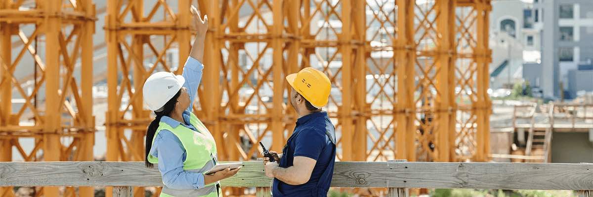 A Man and a Woman with Talking at a Construction Site