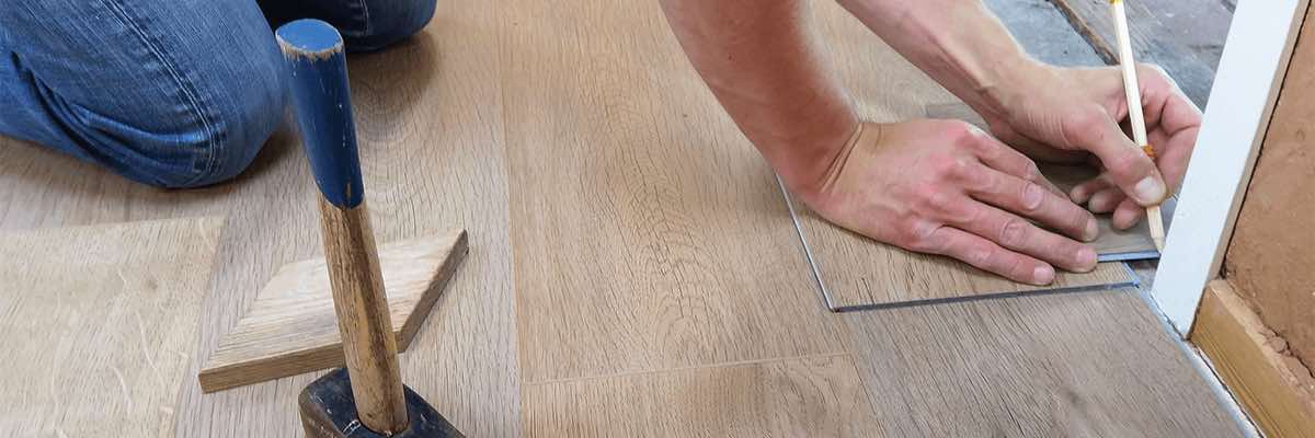 Person installing wood flooring