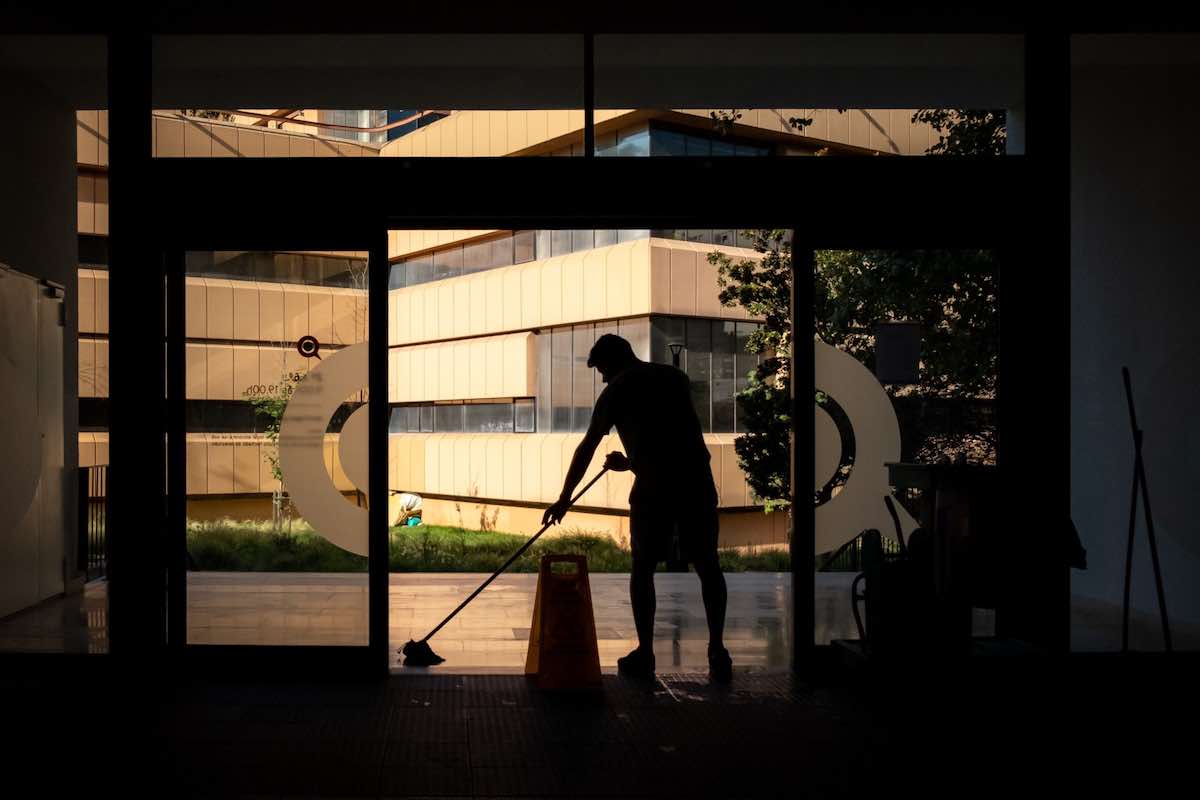 Silhouette of person cleaning a foyer