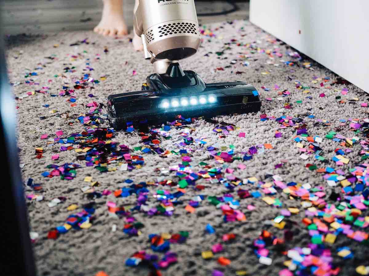 Vaccuum on carpet filled with confetti