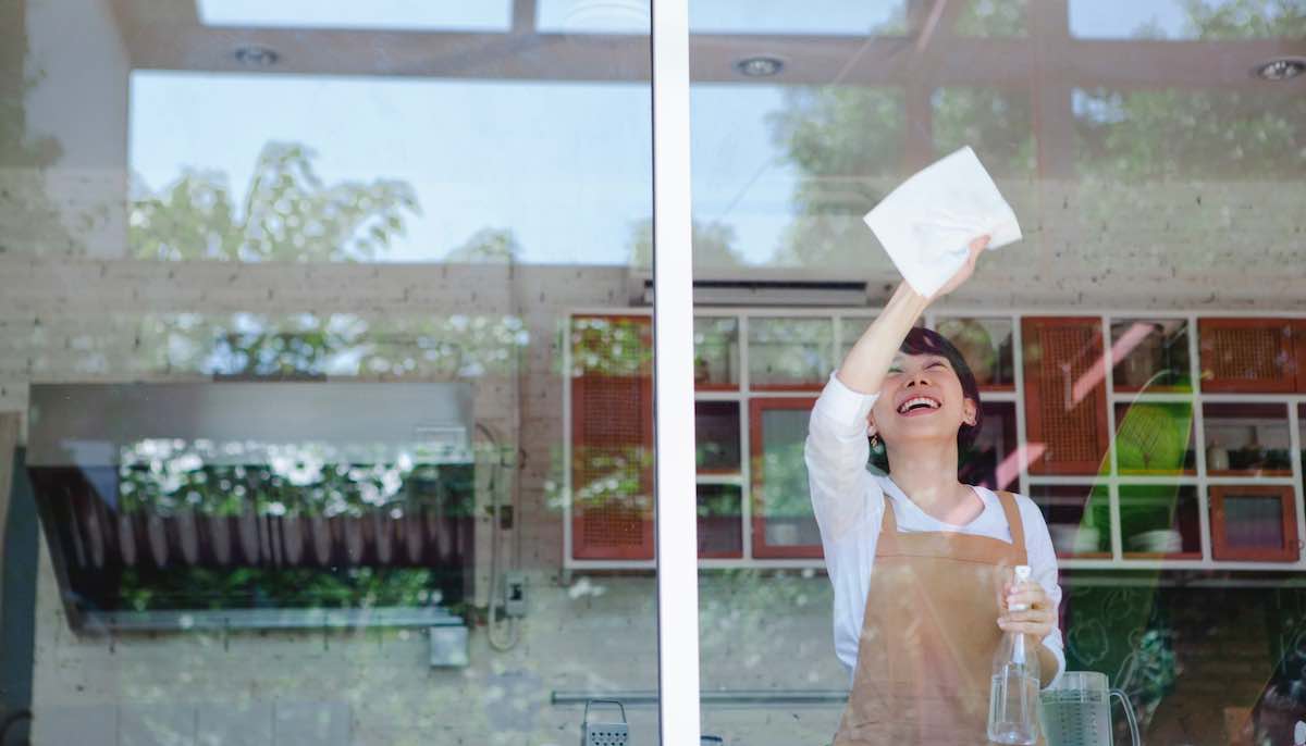 Woman enjoying cleaning windows