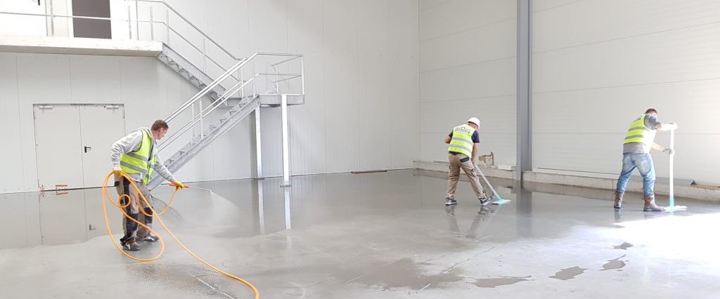 Three men washing the floor