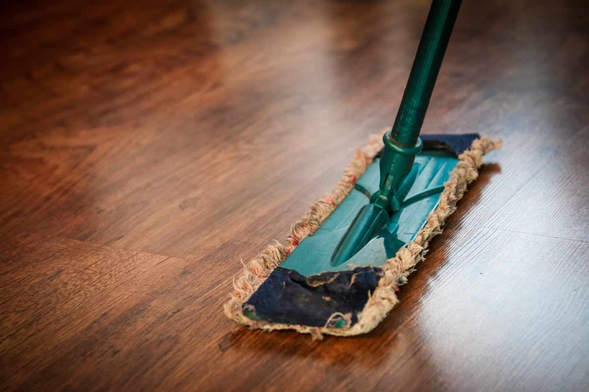 A mop mopping a shiny wooden floor