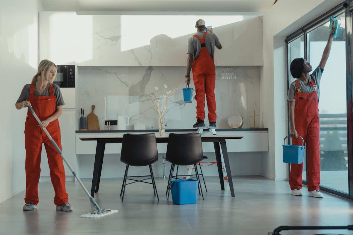 Three people washing an apartment