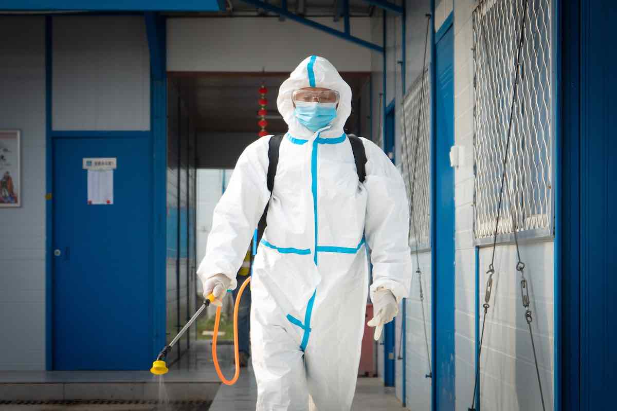 Person in full-body cleaning suit