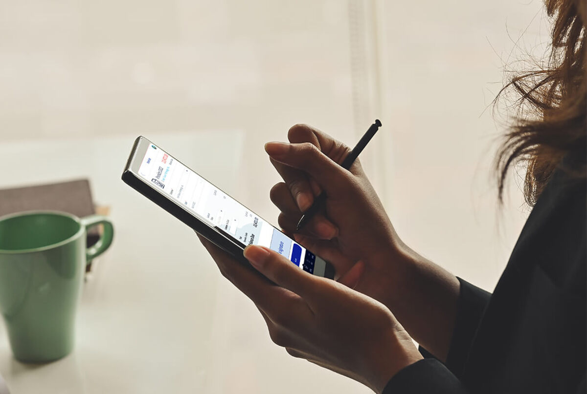 This image shows a woman signing an invoice on her mobile phone through Method:CRM's DocuSign integration.