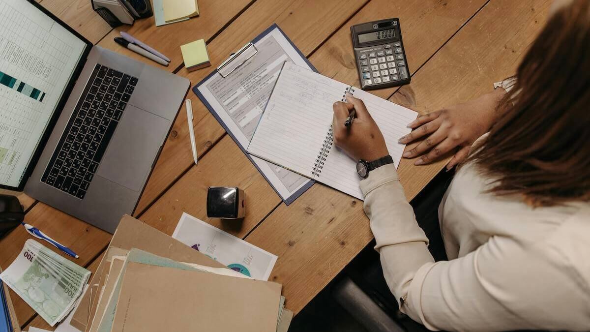 Person in White Long Sleeve Shirt Holding White Paper
