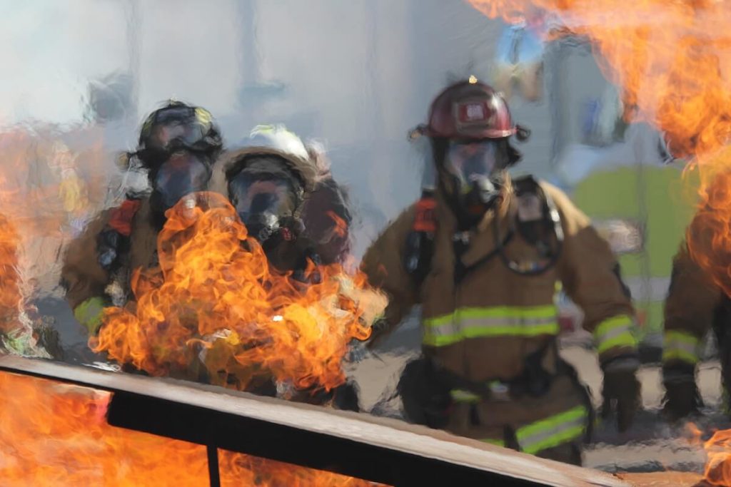 Firefighters rushing towards a fire.