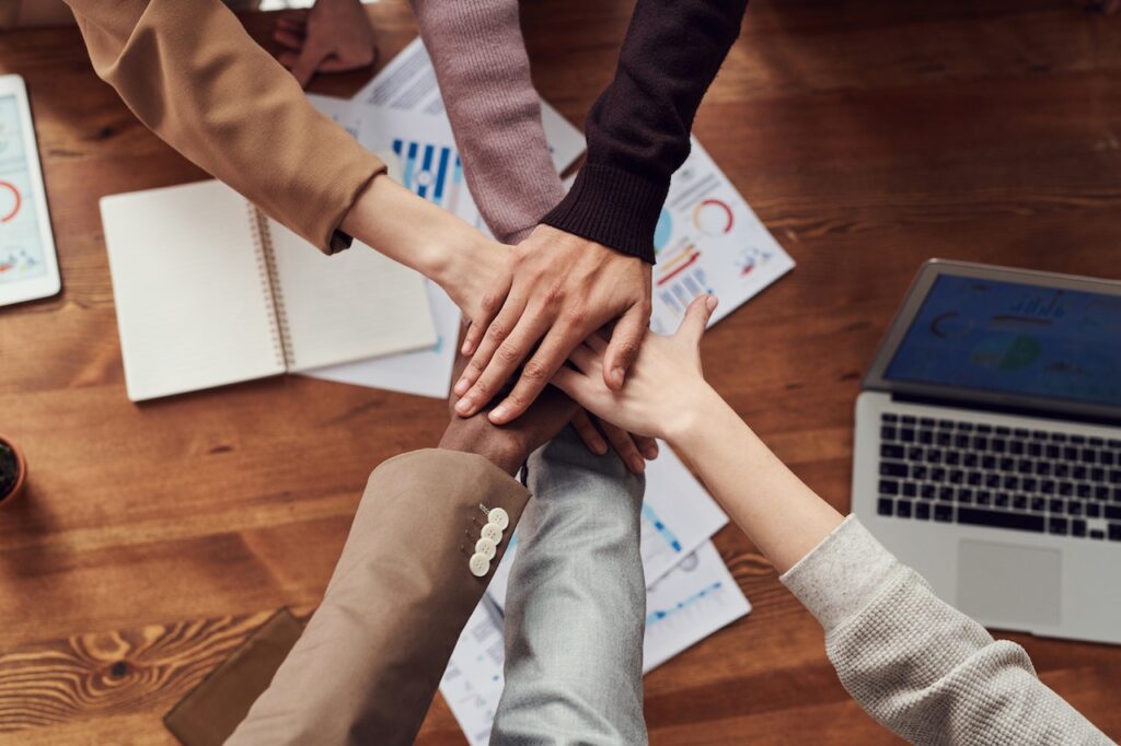 This image shows six people stacking their hands together.