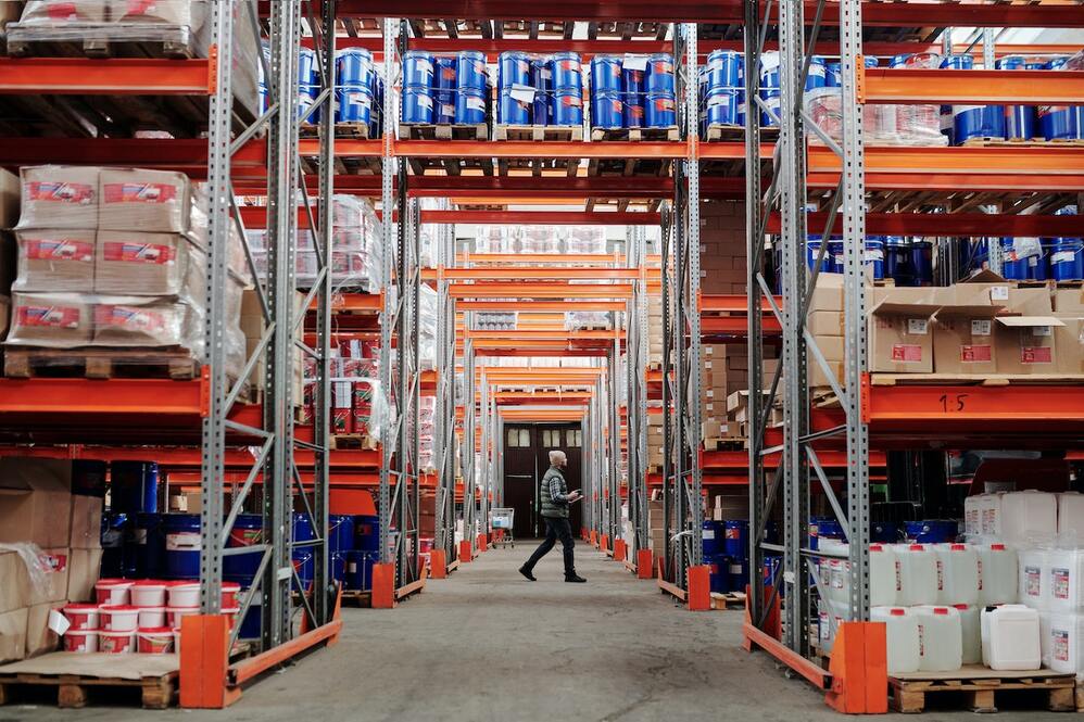Man walking through a packed warehouse.