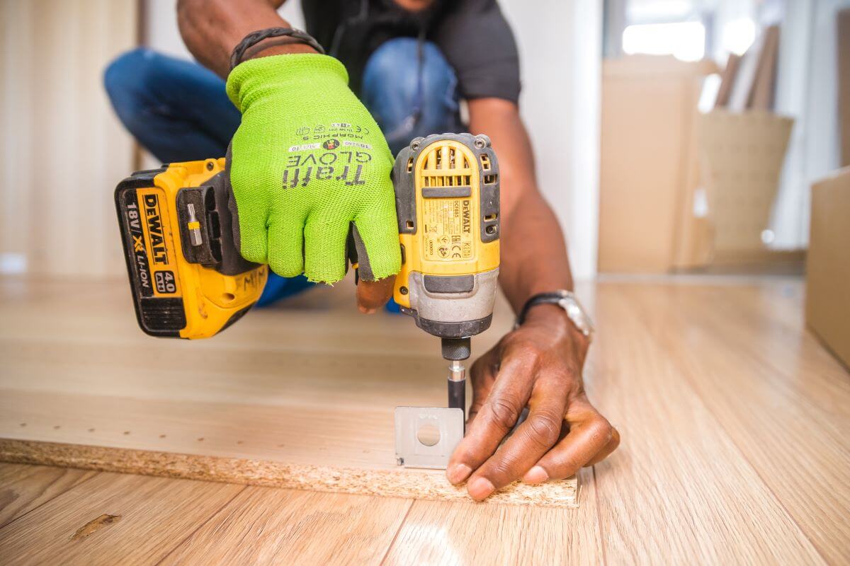 A close-up of someone drilling into a piece of wood.