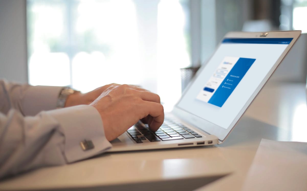 A close-up shot of someone typing on a laptop with a Method portal on screen.