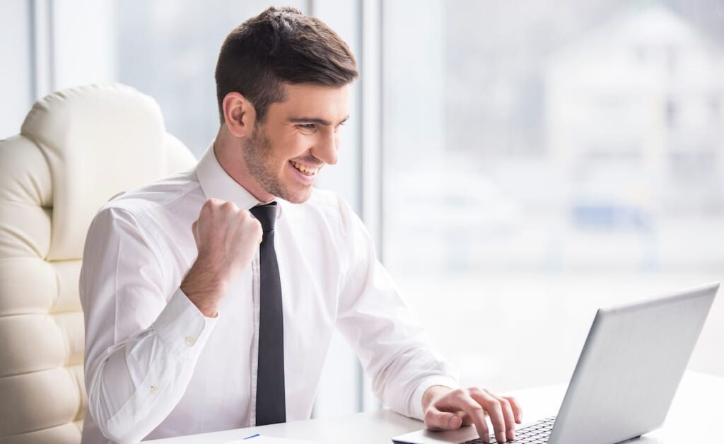 Man really, really happy about his laptop that he fist bumps the air.