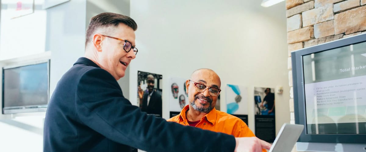 Man pointing at a laptop computer.