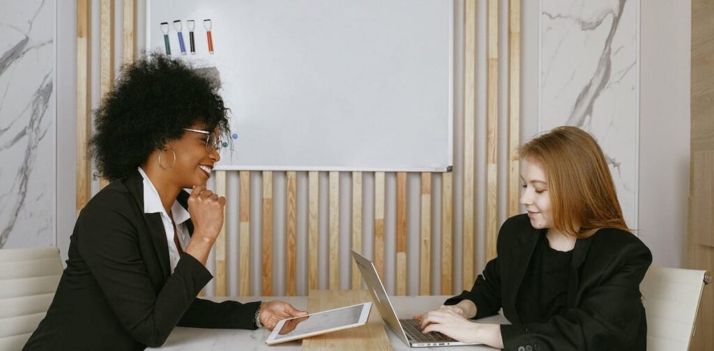 Two business women working in a conference room