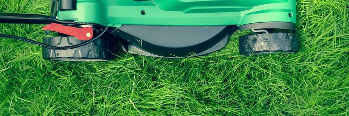 Overhead close-up of a lawnmower on grass