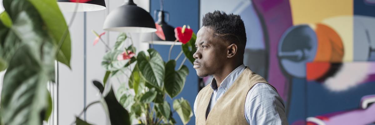 Side view of man holding papers at workplace