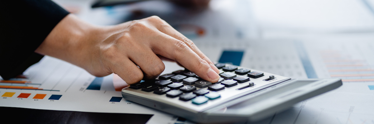 Close up of Businesswomen using a calculator