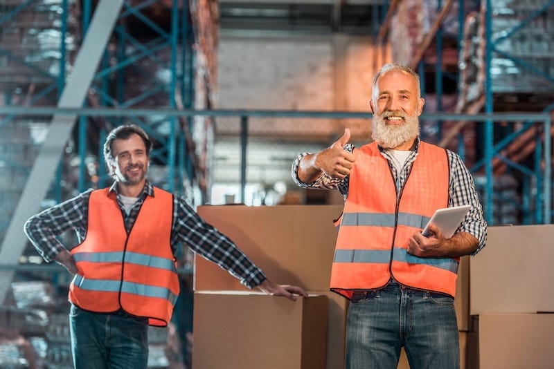 Warehouse workers with digital tablet