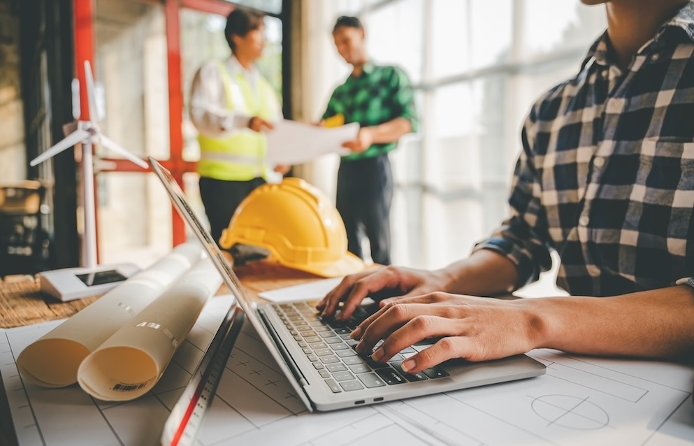 Man working on computer at construction site