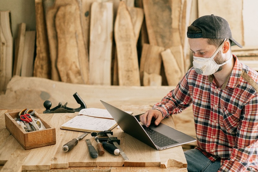 Man looking at computer at construction site