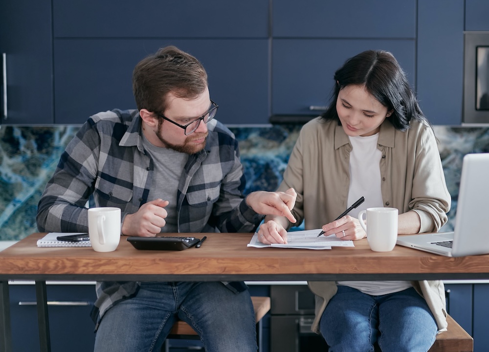 Man and woman checking documents on a table