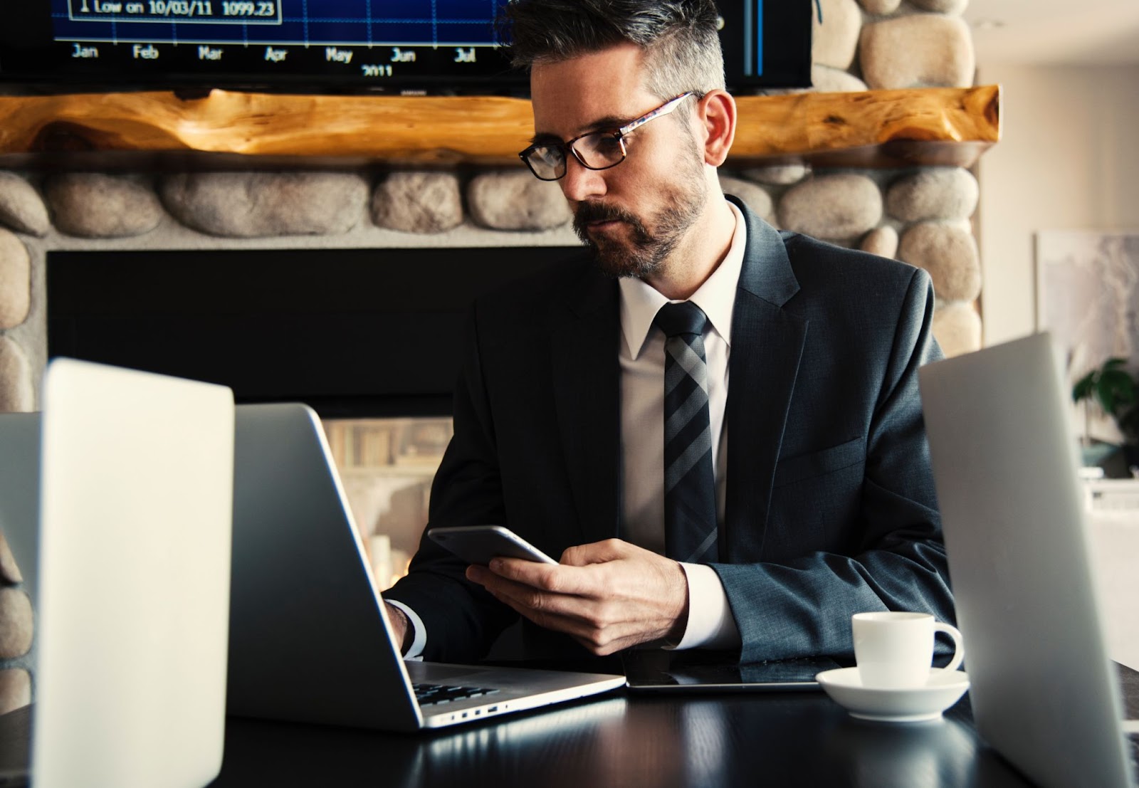 Businessman working on phone and computer