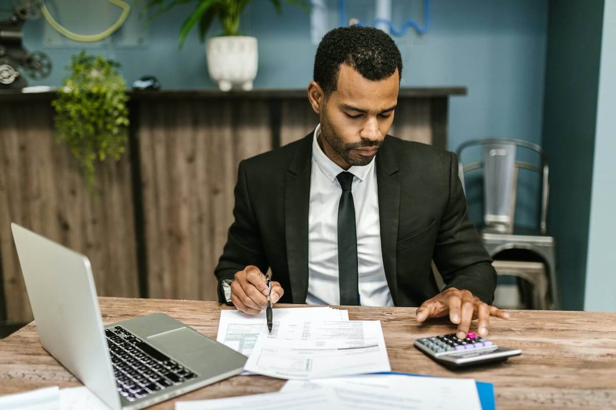 Man in black suit working