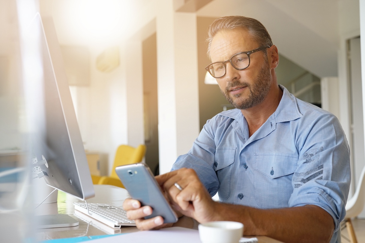 Home-office worker using smartphone