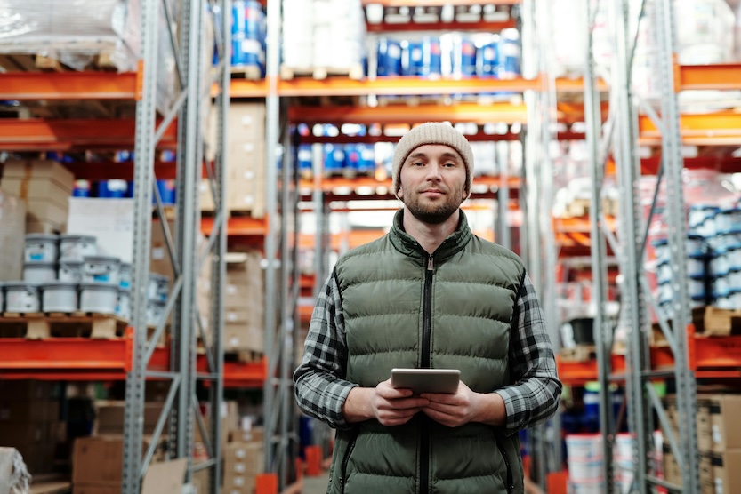 Man in warehouse holding a tablet