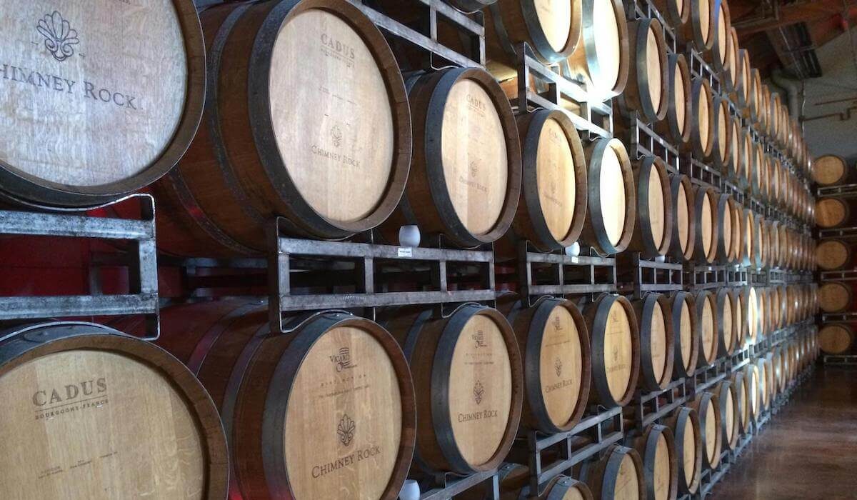 A wall of casks in a wine cellar.