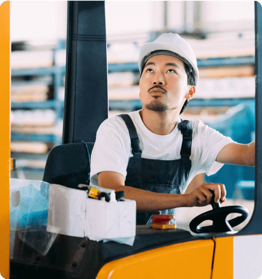Forklift operator in a warehouse setting.